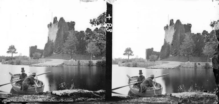 Boatman with Ross Castle in the background in Killarney circa 1900